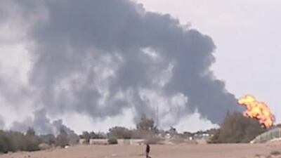 A burning oil facility near Ras Lanuf, eastern Libya, set alight as forces loyal to Muammar Qaddafi and rebels clashed.