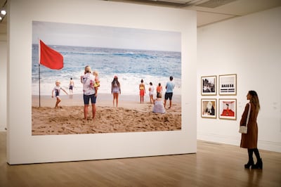 A visitor looks at photographs displayed at the Only Human: Photographs by Martin Parr exhibition. AFP