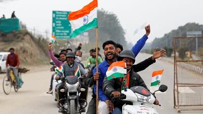 People ride motorbikes before the arrival of Indian Air Force pilot, who was captured by Pakistan on Wednesday, near Wagah border, on the outskirts of the northern city of Amritsar, India, March 1, 2019. Reuters
