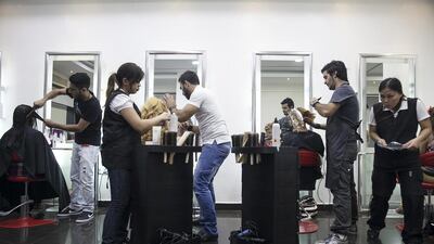 Hairstylists work away the night at the Lebanese operated hair salon Artistic Hair. The salon owner, Nicholas Baaklini, opened the salon 7 years ago and has built a solid clientele and reputation.
