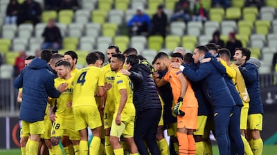 Villarreal players in a huddle before the penalty shootout. EPA