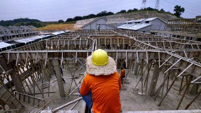 A construction worker rests on a rooftop at a housing construction project area in Bukit Raja Klang outside Kuala Lumpur. Malaysia’s government on February 28 announced that the higher threshold price for foreigners to own property will go into effect from March 1 in federal administered territories. Samsul Said / Reuters