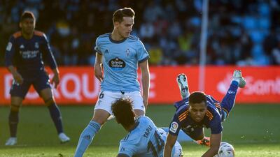 Real Madrid forward Rodrygo falls as he is tackled by Celta Vigo midfielder Renato Tapia. AFP