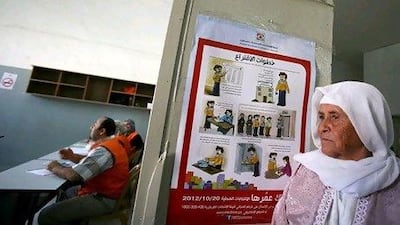 A Palestinian woman waits to vote for the municipal elections at a polling station yesterday.