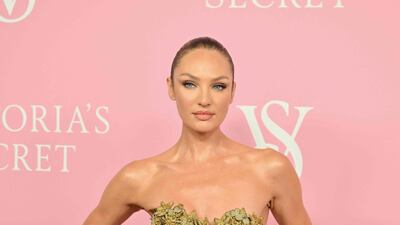 Former Victoria Secret 'angel' Candice Swanepoel wears a tightly corseted mini-crini dress, finished with gold flowers. AFP