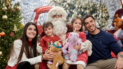 A family poses with Santa Claus at Our Lady of Lebanon church before Christmas. Photo credit: Nilanjana Gupta