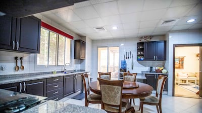 A spacious kitchen features a dining table.