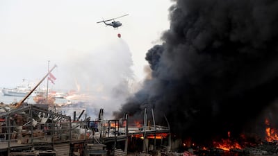 A helicopter tries to put out a fire that broke out at Beirut's port area. Reuters