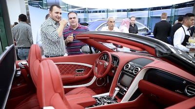 Visitors take a closer look at a Bentley at the new Al Habtoor Motors facility in Dubai. Ravindranath K / The National