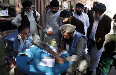 Men from the minority Sikh register to cast their votes in Parliamentary elections in old city of Kabul, Afghanistan. AP