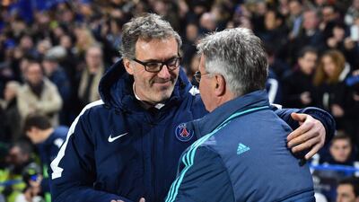 Chelsea’s interim manager Guus Hiddink, right, greets Paris Saint-Germain coach Laurent Blanc before kick off. Ben Stansall / AFP
