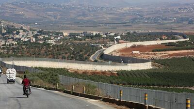 A man rides a motorbike in Adaisseh village, near the Lebanese-Israeli border