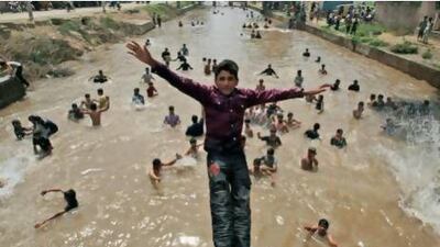 A boy jumps into a canal as he and other youths try to beat the heat in Lahore, Pakistan. KM Chaudary / AP Photo