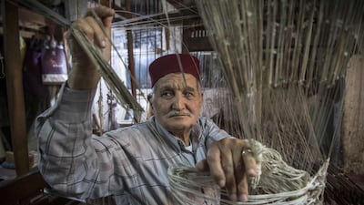 He uses a large wooden frame topped with beams, rafters, blades, pulleys and counterweights. AFP
