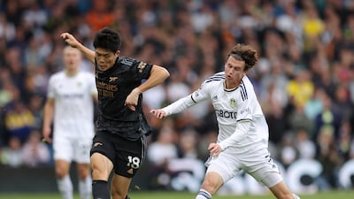 Takehiro Tomiyasu of Arsenal is challenged by Brenden Aaronson of Leeds United. Getty