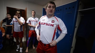 Crimea rugby union players get dressed in the locker room prior to their match v Russia on Saturday. Filippo Monteforte / AFP / March 15, 2014
