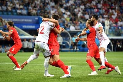 Harry Kane of England and Yassine Meriah, right, of Tunisia clash. Getty
