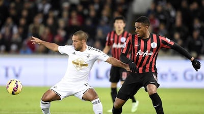 Swansea City''s Wayne Routledge, left, tries to control the ball against Queens Park Rangers' Leroy Fer during Swansea's 2-0 Premier League win at the Liberty Stadium on Tuesday night. Rebecca Naden / Reuters