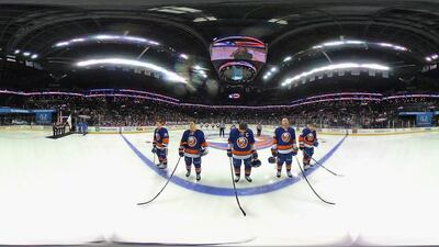 The New York Islanders and the Calgary Flames stand at attention during the national anthem before their game at the Barclays Center in Brooklyn, New York, on November 28, 2016. Bruce Bennett / AFP