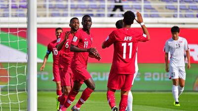 Qatar forward Almoez Ali, third left, celebrates after scoring against North Korea. AFP