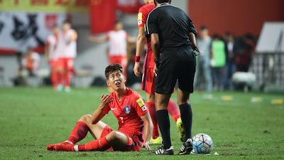Son Heung-min of South Korea talks to referee Mohammed Abdulla Hassan after being fouled during the 2018 World Cup qualifier against China at Seoul World Cup Stadium on September 1, 2016. Chung Sung-jun / Getty Images