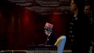 People watch news on a screen to follow the results of the final day of the US presidential election at an event organised by the American consulate in Shanghai. Johannes Eisele / AFP