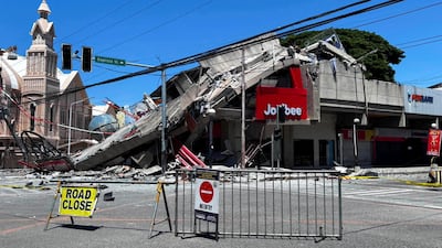 A road is blocked near a collapsed building after a magnitude-7.8 earthquake in General Santos City, the Philippines. Reuters