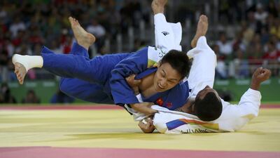 Ilias Iliadis (GRE) of Greece and Cheng Xunzhao (CHN) of China compete. REUTERS/Toru Hanai