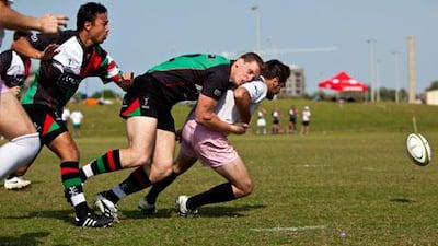 Michael Mc Farlane of the Abu Dhabi Harlequins tackles a Frog's player during a game on Friday at Zayed Sports City.