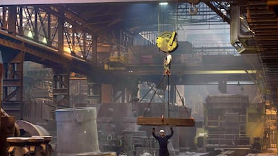 A worker sets a pit for casting a steel ingot in the melt shop. Oli Scarff / AFP
