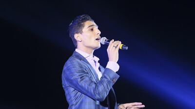 Mohammed Assif sings in Dubai on Friday night after high winds forced the postponement of a film about his life. Sarah Dea / The National