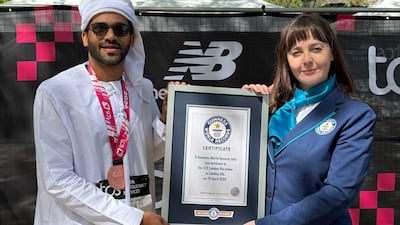 Sadique Ahamed being presented with a certificate for his achievement at the end of this year's London Marathon. Photo: Guinness World Records