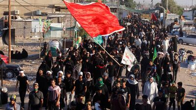 Pilgrims walk to the city of Karbala to mark the ritual of Arbaeen, amid the outbreak of the coronavirus disease in southern Iraq on October 6, 2020. Reuters