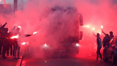 Football fans light flares as team buses arrive before the match between Rennes and Lille in France. Reuters