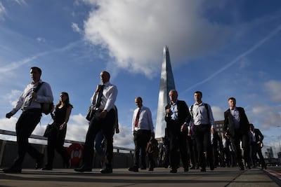 Commuters walk across London Bridge after it was partially re-opened following the terror attack. AFP