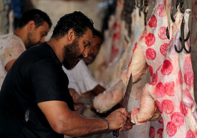 Butchers cut meat inside a slaughterhouse ahead of Eid Al Adha in Giza, on the outskirts of Cairo in July 2021. Reuters
