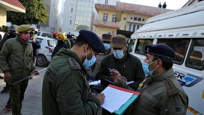 Police officers record details of those who died in the stampede at the shrine. AP Photo