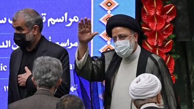 Iran's newly elected President Ebrahim Raisi waves as he arrives for his swearing in ceremony at the Iranian parliament in the capital Tehran.