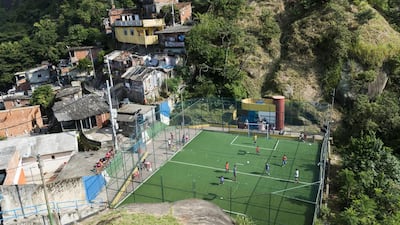 Children playing on the small football pitch in the favela of Santa Marta in Rio de Janeiro, Brazil. Bob Thomas / Popperfoto / Getty Images)