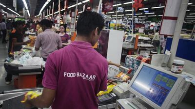 Store assistants help customers check out at the Big Bazaar Hypermarket store in Noida, India. Prashanth Vishwanathan / Bloomberg