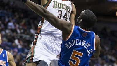 Milwaukee rookie Giannis Antetokounmpo lays it up over New York rookie Tim Hardaway Jr on Monday night. Tim Lynn / AP