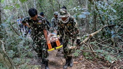 French national Muriel Benetulier is transported on a stretcher by Thai park rangers after she was bitten by a crocodile. BMI / AFP