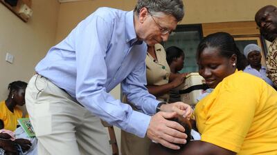 Microsoft co-founder Bill Gates, one of the world’s richest men and highest profile aid donors, gives to a child a rotavirus vaccine in Awutu Senya, Ghana. Puis Utomi Ekpei / AFP