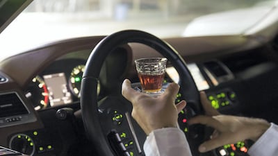 Salem Ahmed receives his tea while cruising around Old Ras Al Khaimah. Chris Whiteoak / The National