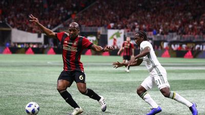 Atlanta United's Darlington Nagbe chases the ball with Portland Timbers' Diego Chara. Reuters