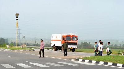 Indian Lambadi tribal students and villagers cross National Highway 44. Noah Seelam / AFP