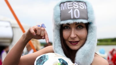 The hostess shows off a piece of Lionel Messi's cake. Argentina fans and local villagers of Bronnitsy gathered to celebrate Lionel Messi's 31st birthday. Getty