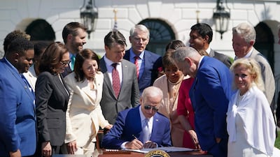 President Joe Biden signs the CHIPS and Science Act of 2022, on the South Lawn of the White House in Washington on Tuesday. AFP