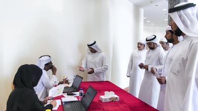 Fujairah residents visit the Ministry of Culture and Knowledge Development to check if they have been granted homes in Sheikh Mohamed bin Zayed City. Reem Mohammed / The National