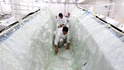 Clean-room operators work on a flap track fairing Strata. Jumana El Heloueh / Reuters